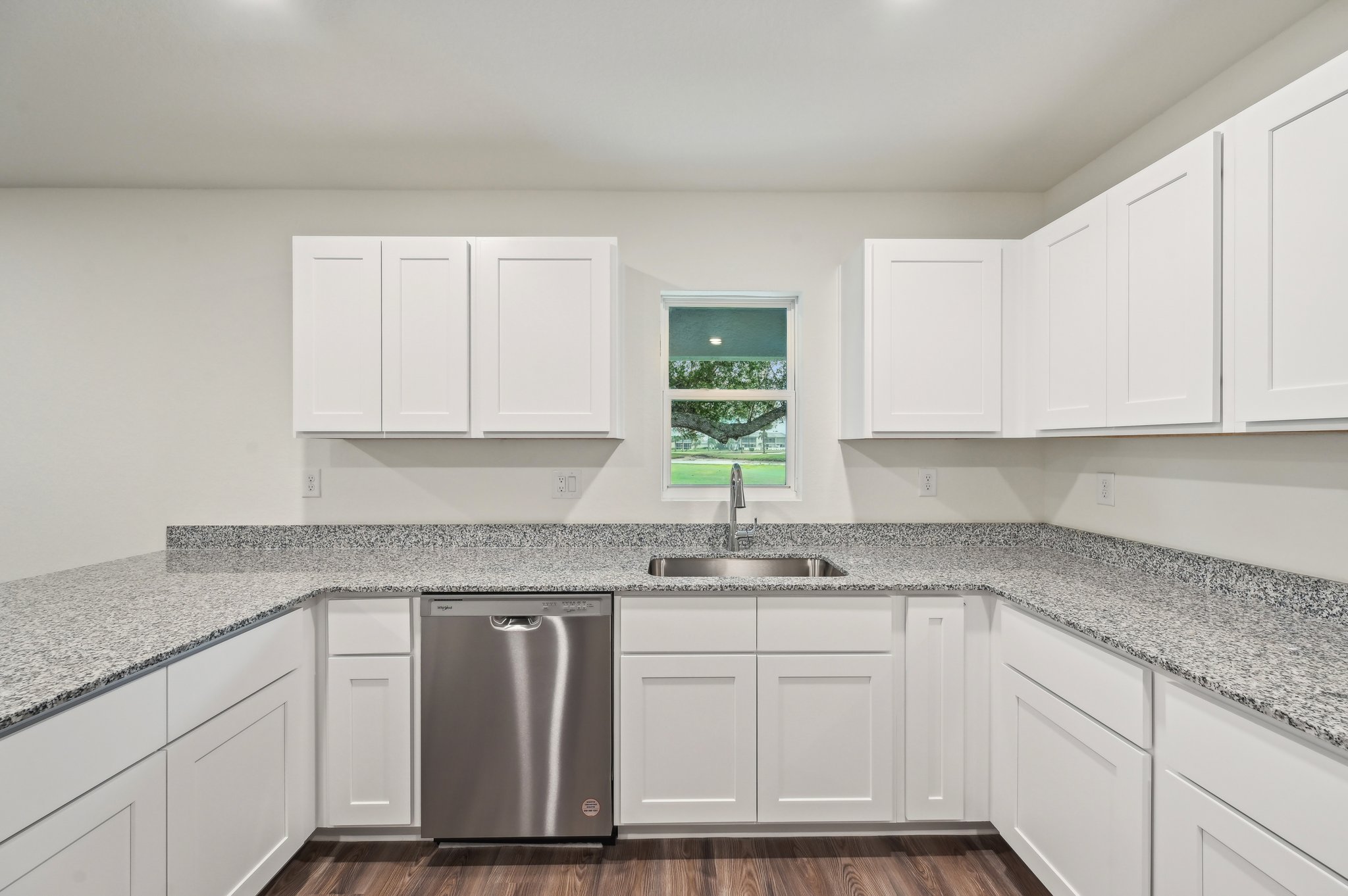 A kitchen with white cabinets.