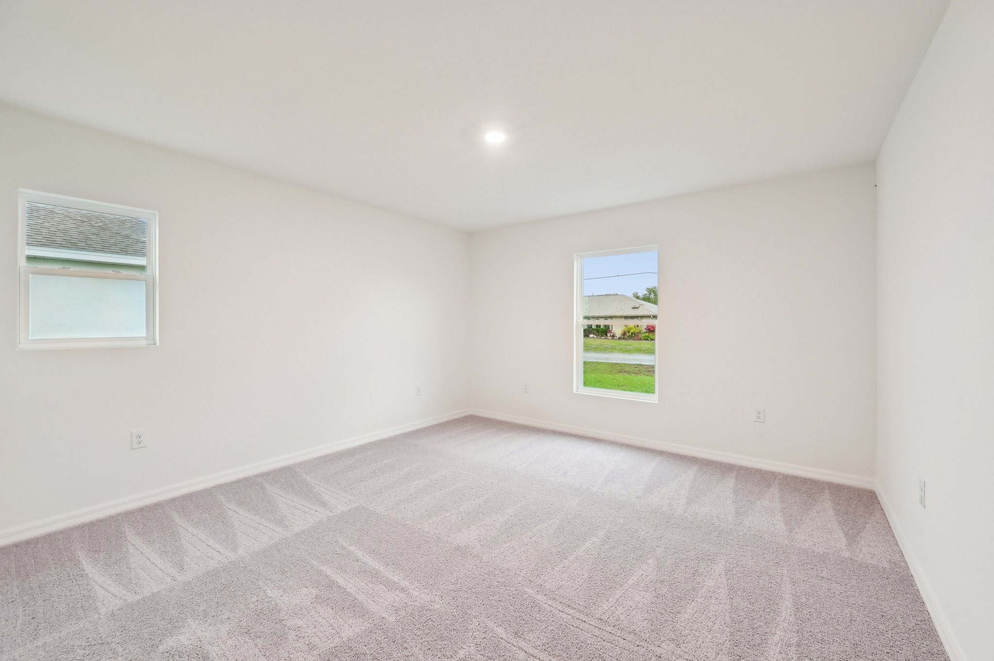 A room with a carpet and a window.