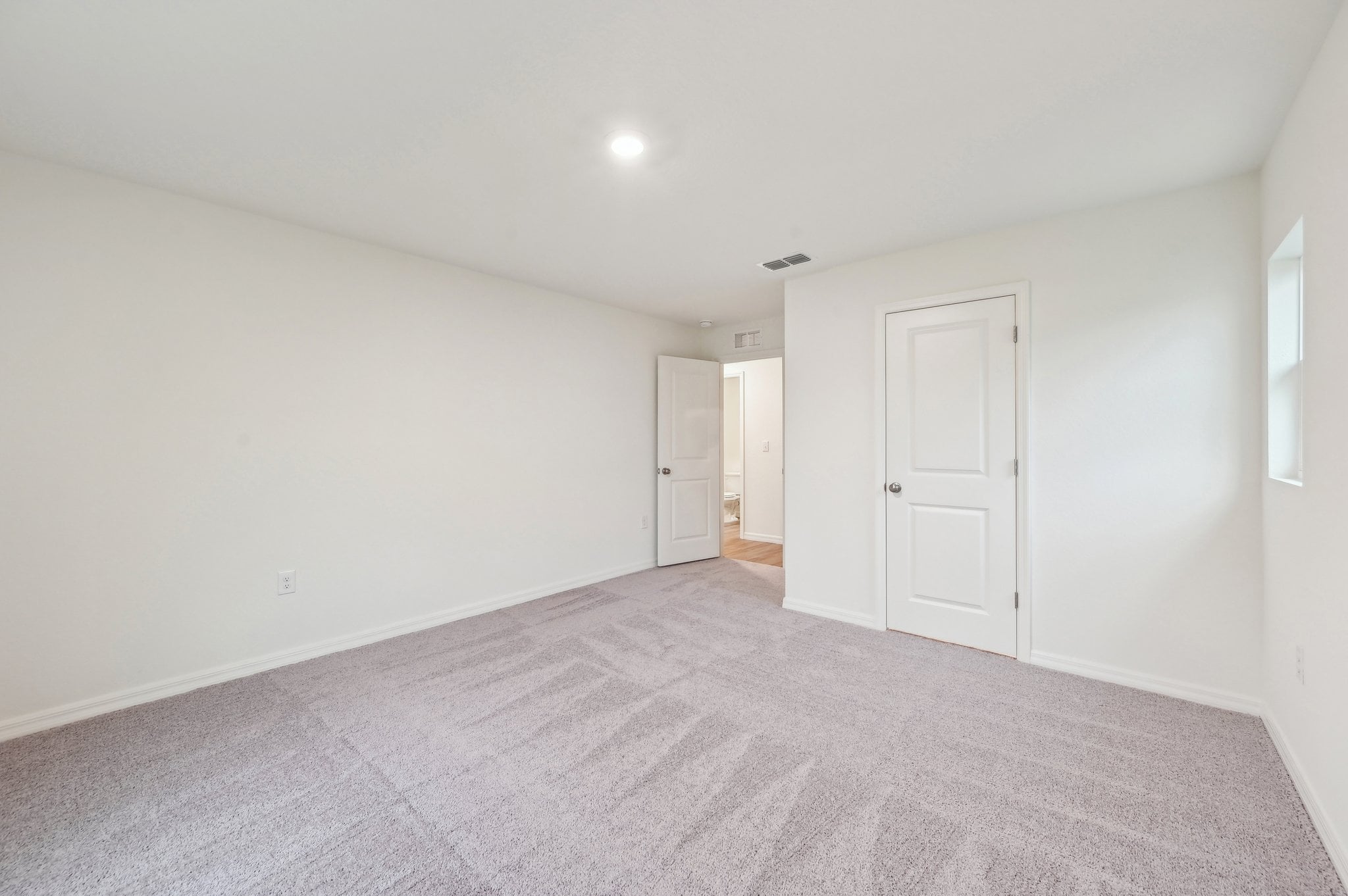 A hallway with white doors.