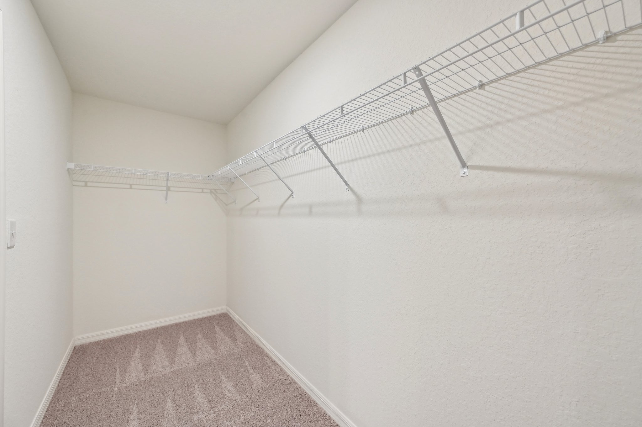 A white room with a carpet.