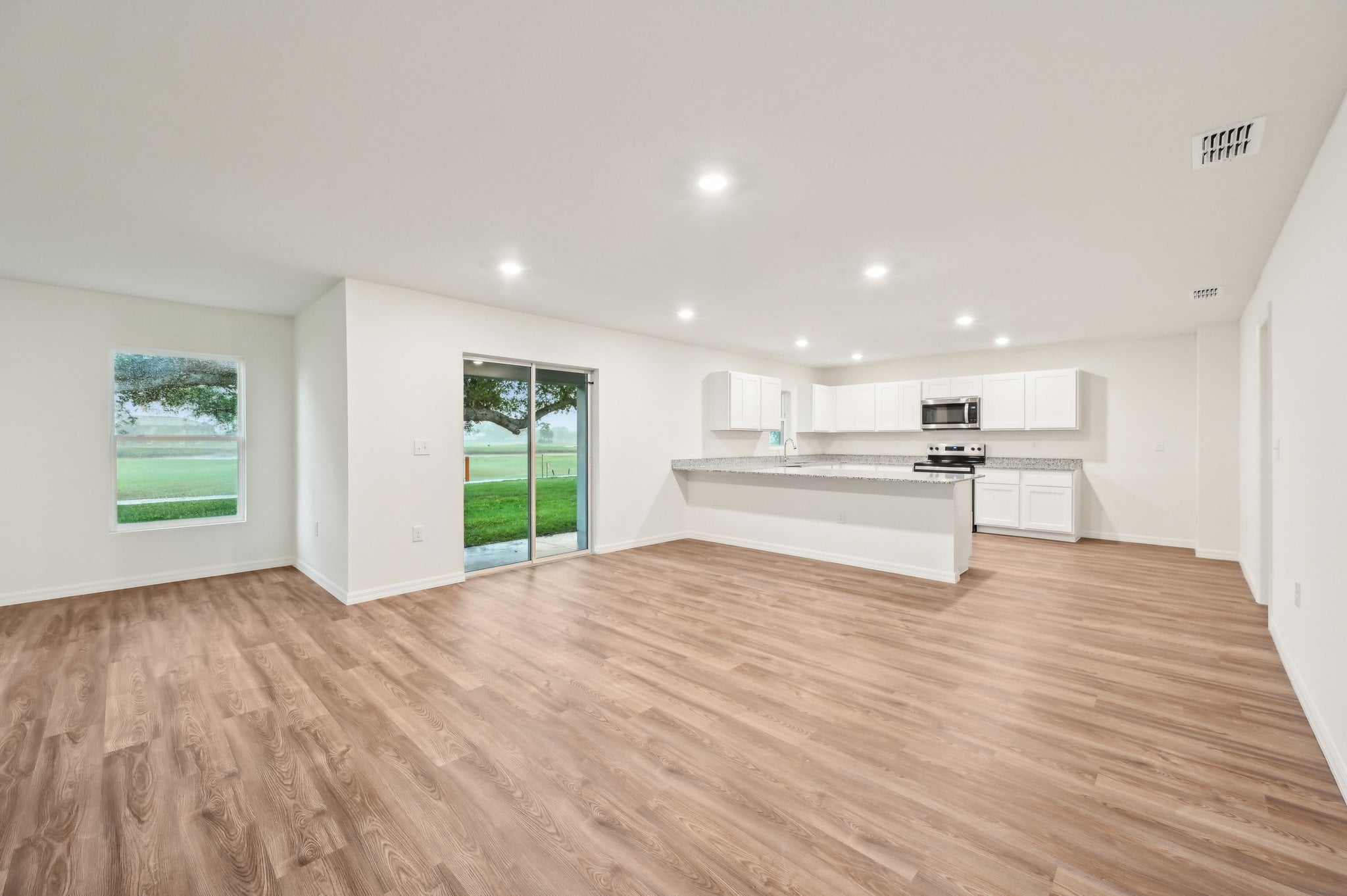 A large kitchen with white cabinets.