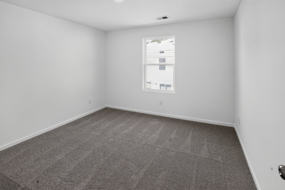 A room with a tile floor and a window.