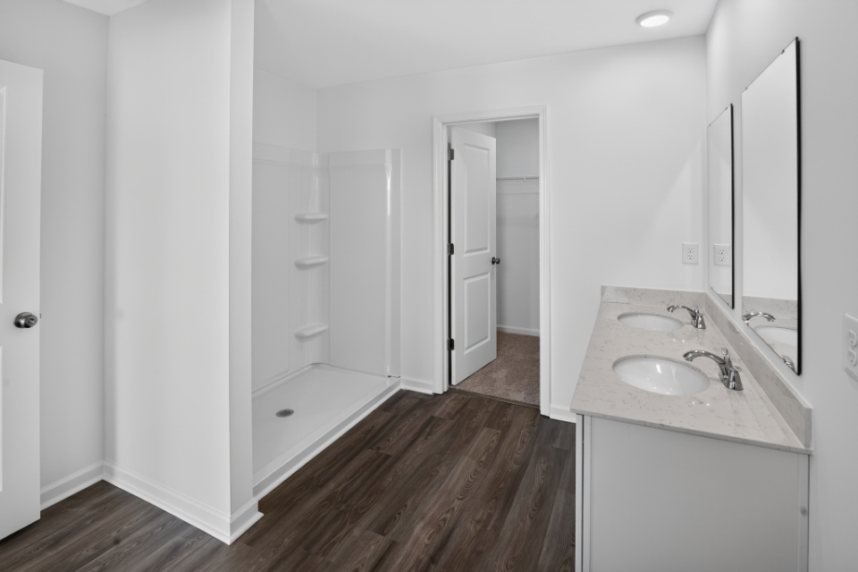 A bathroom with a wood floor.