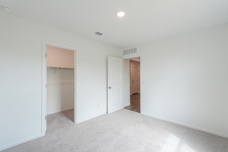 A hallway with white walls.