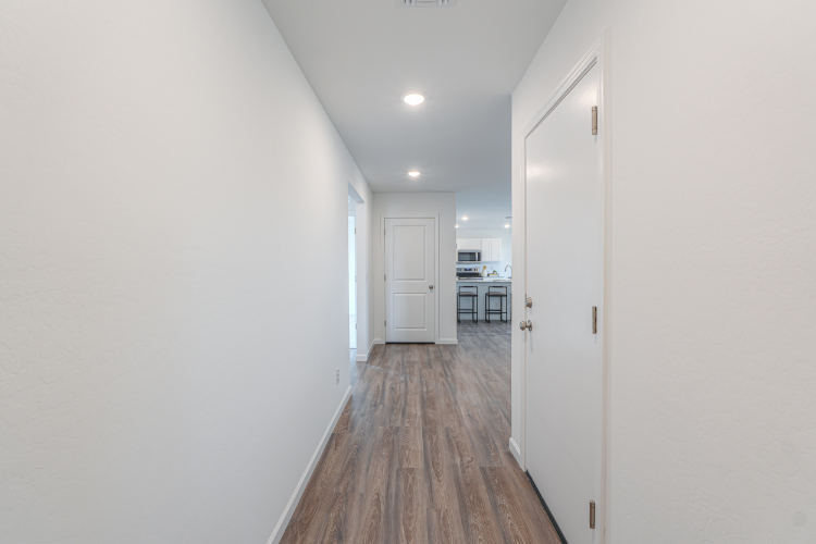 A hallway with white doors.
