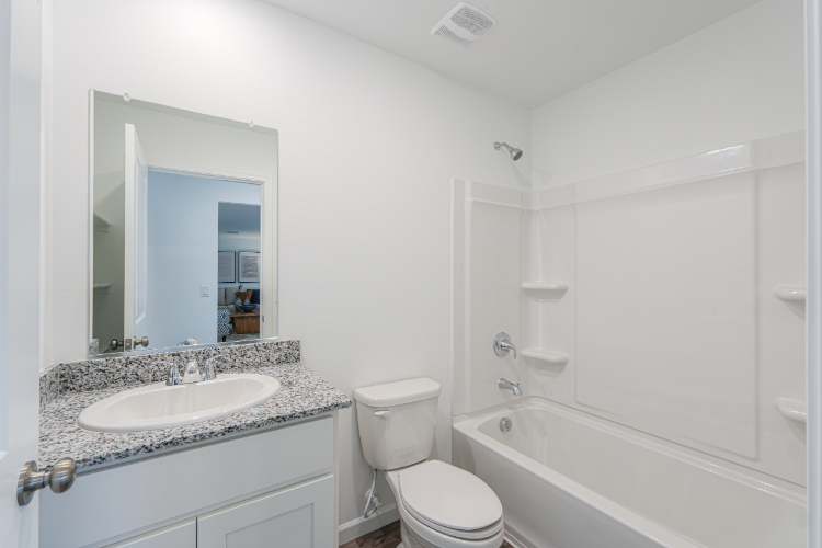 A bathroom with a sink toilet and bathtub.