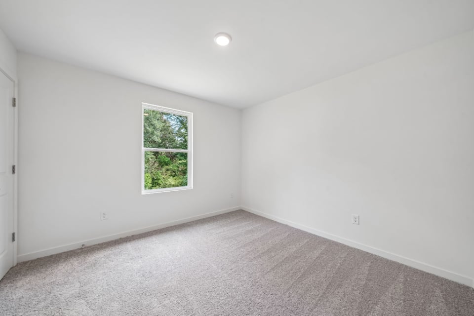 A room with a window and a door.