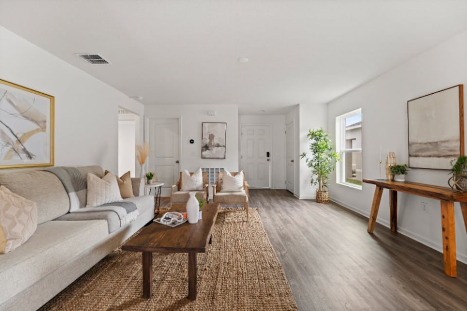 A living room with a wood floor.