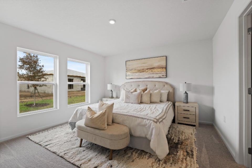 A bedroom with a bed and a couch.