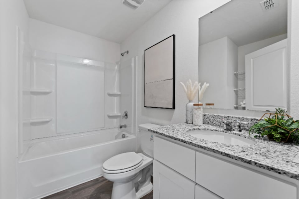 A bathroom with a tub sink and toilet.