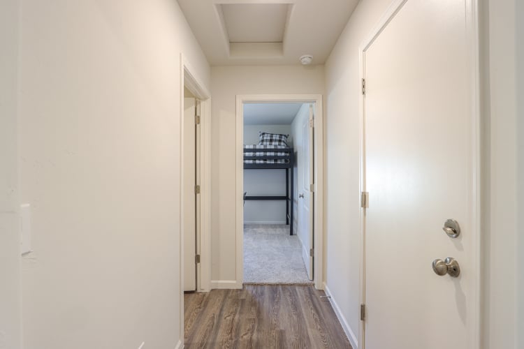 A hallway with white doors.