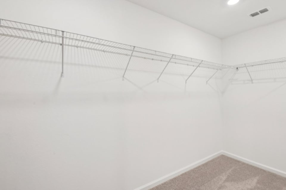 A white room with a metal railing.