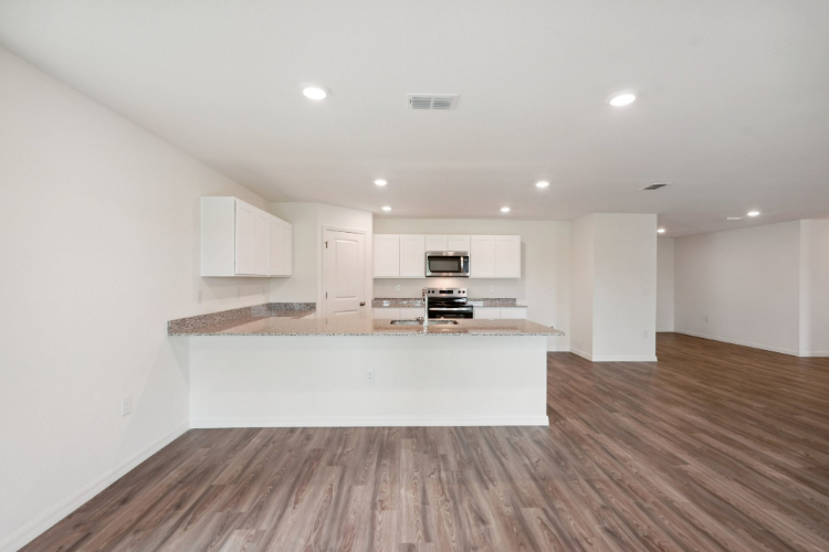 A kitchen with white cabinets.