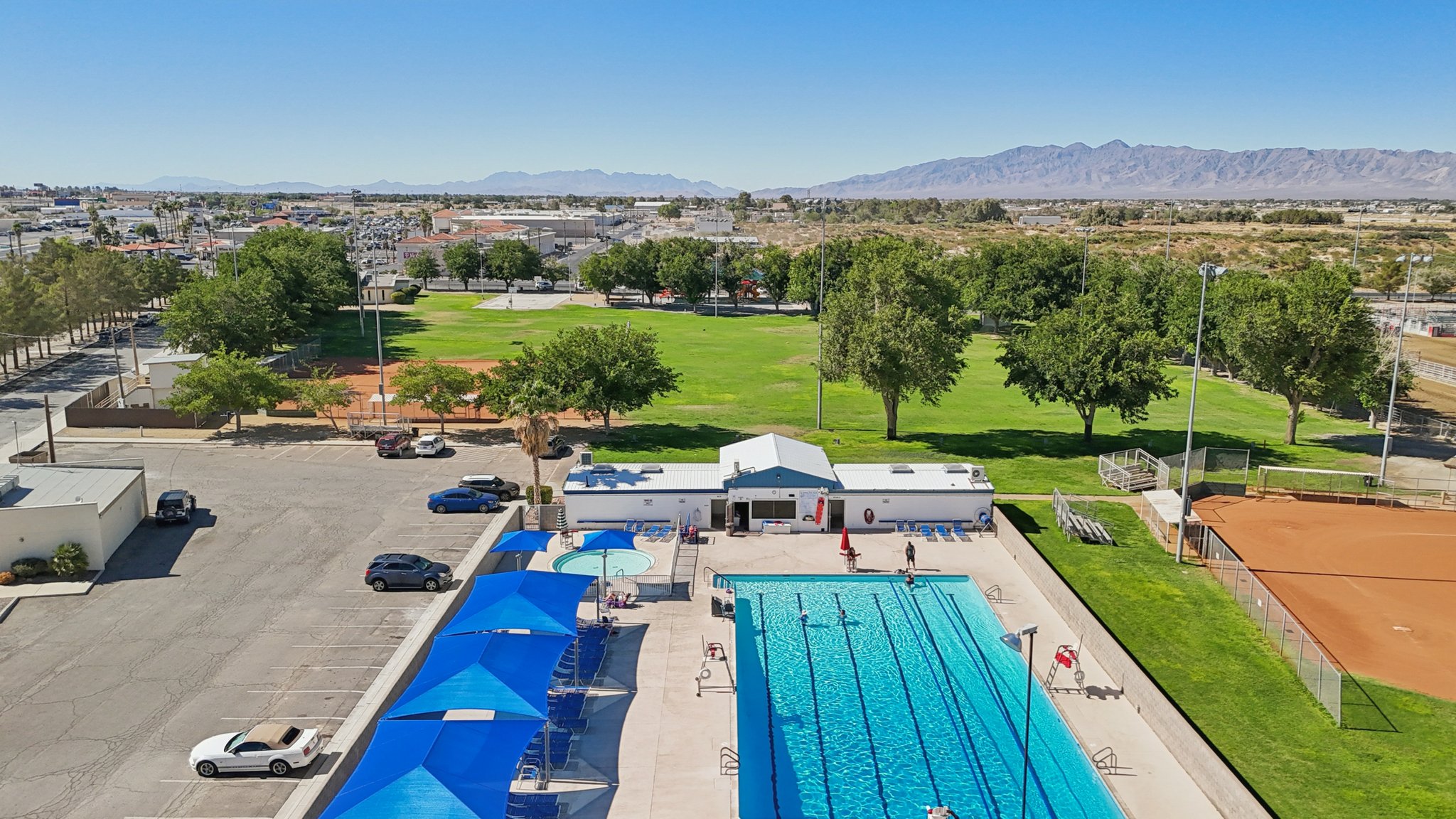A swimming pool with a building in the background.