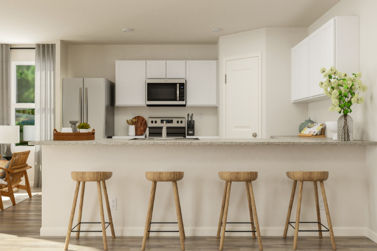 A kitchen with white cabinets.