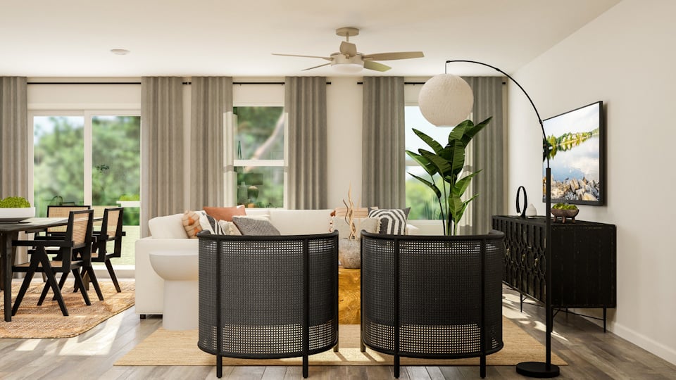A living room with a white couch and a black table.