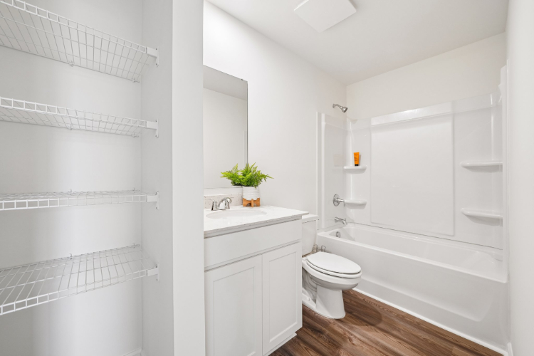 A bathroom with white walls.