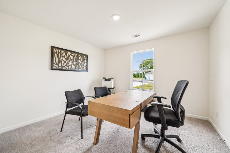 A room with a table and chairs.