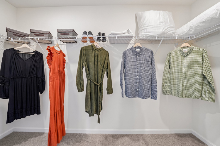 A group of clothes on a rack.