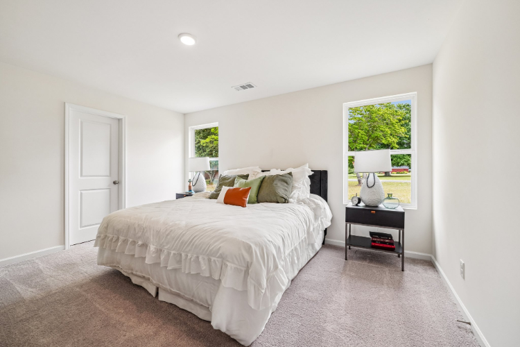 A bedroom with a bed and a desk.