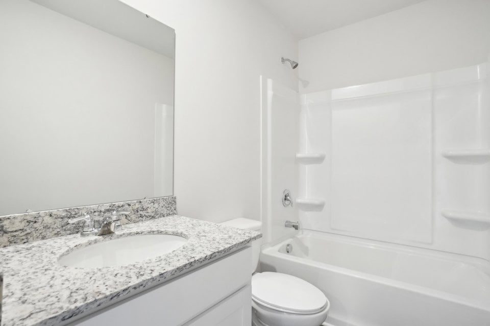 A bathroom with a marble countertop.