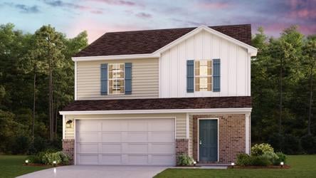 A house with a garage and trees in the back.