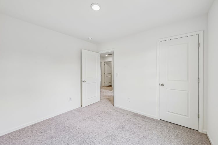 A hallway with white doors.