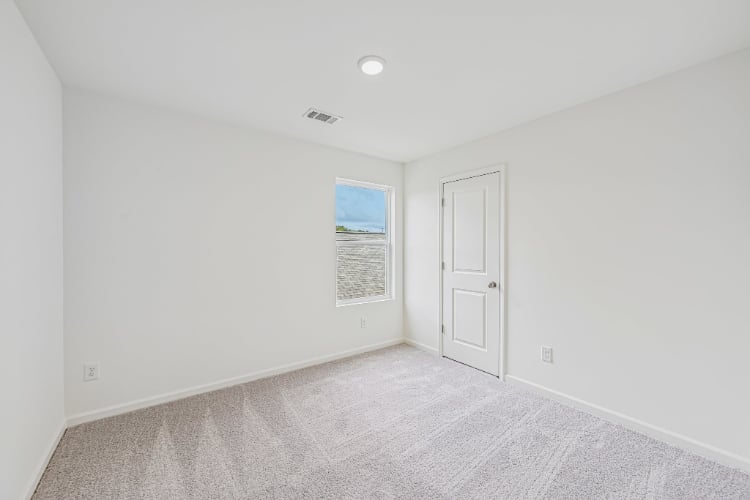 A hallway with white walls.