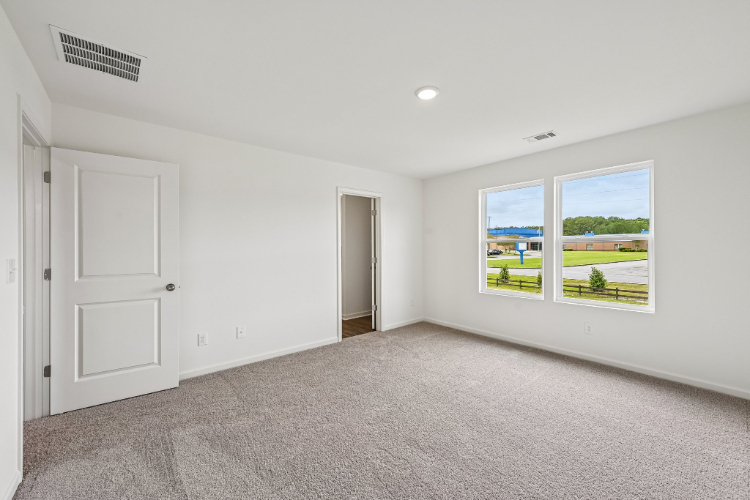 A room with white walls and a window.
