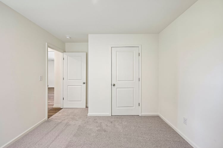 A hallway with white doors.