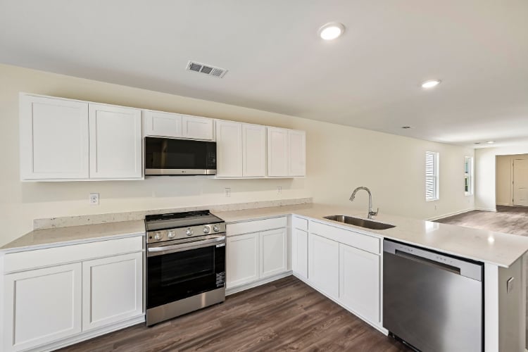 A kitchen with white cabinets.