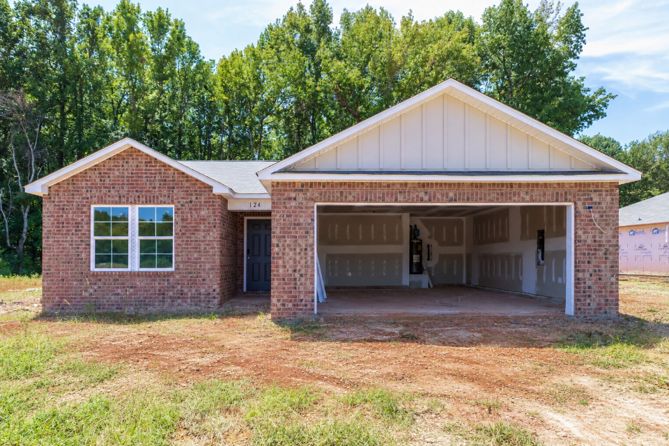 A brick house with a garage.