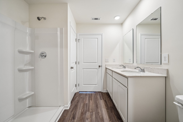A bathroom with a sink and shower.