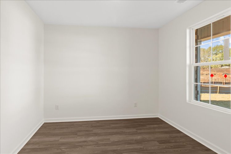 A room with a wood floor and a window.