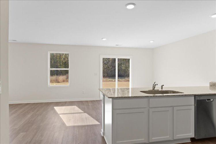 A kitchen with a large window.