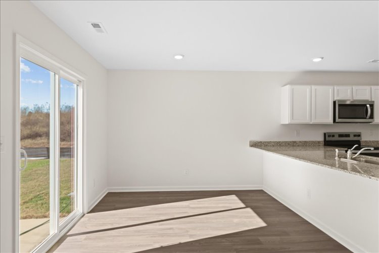 A kitchen with a large window.