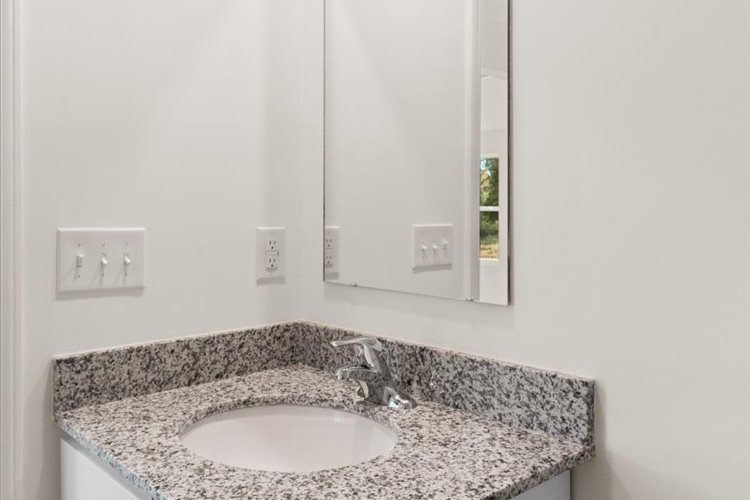 A bathroom with a marble countertop.