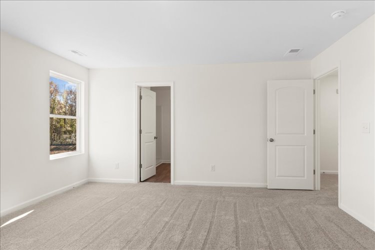 A room with white walls and a window.