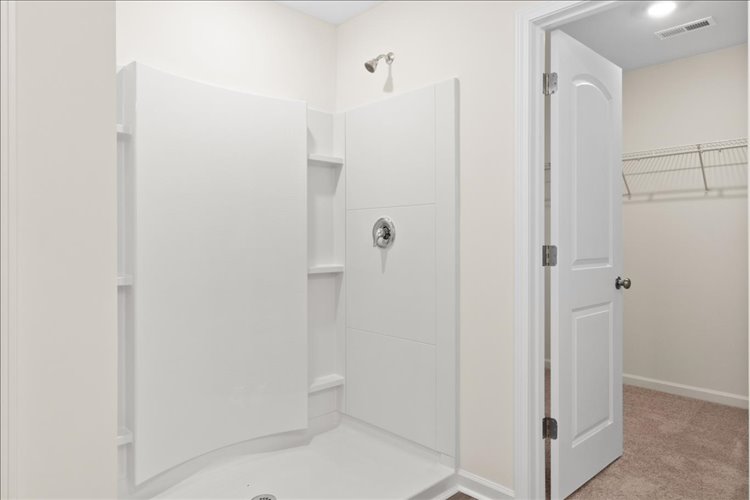 A bathroom with white doors.