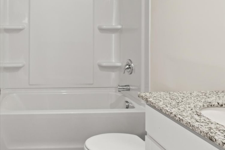 A bathroom with a marble countertop.