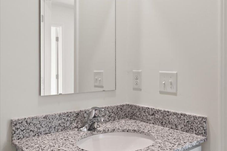 A bathroom with a marble countertop.