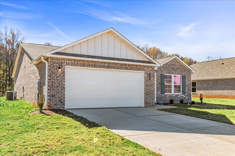 A house with a garage with American Gothic House in the background.