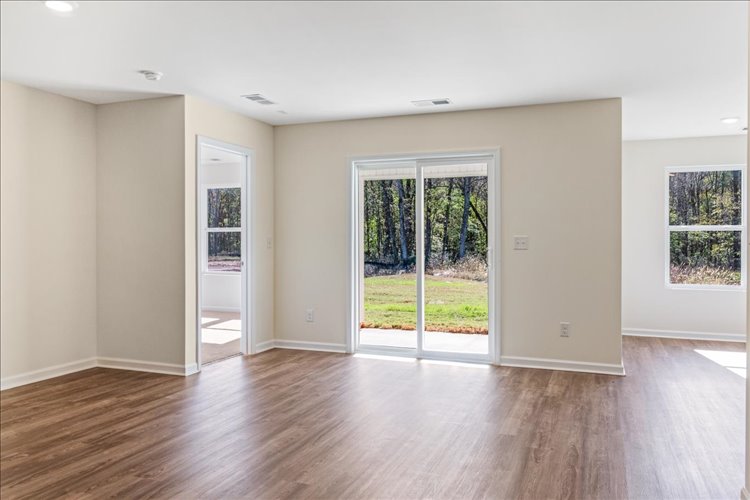 A room with a wood floor and white walls.