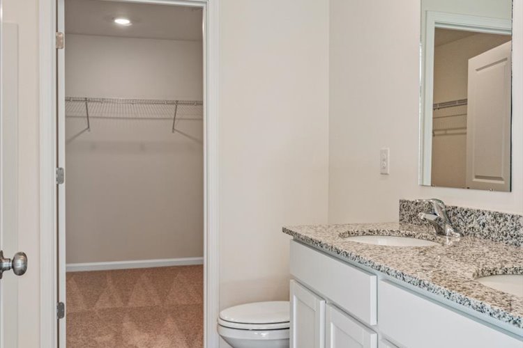 A bathroom with a marble countertop.