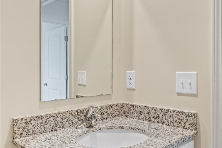 A bathroom with a marble countertop.