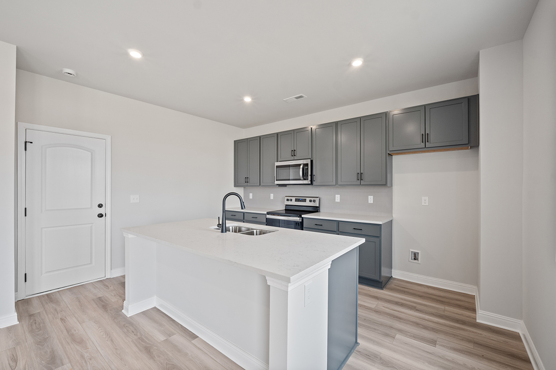 A kitchen with white cabinets.