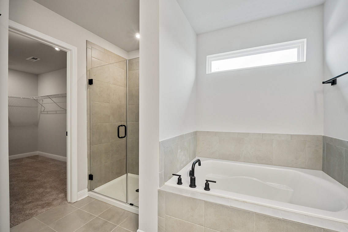 A bathroom with a tub and shower.