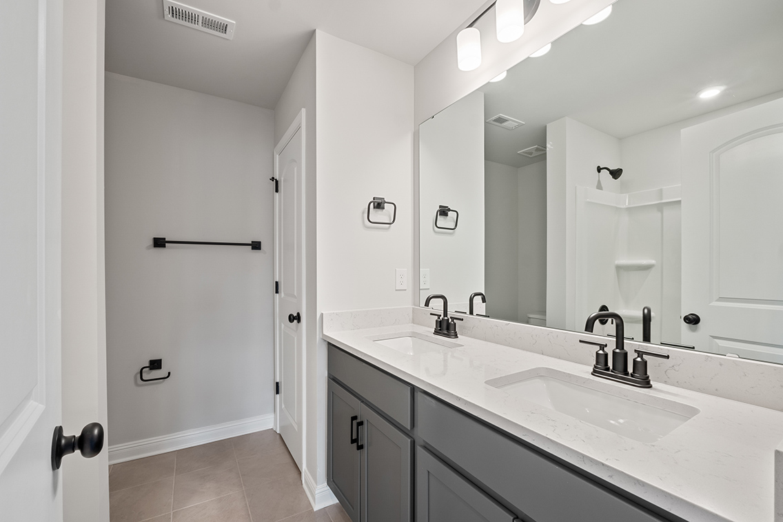 A bathroom with a large mirror.