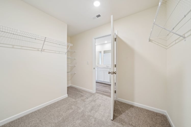 A hallway with a door and a glass window.