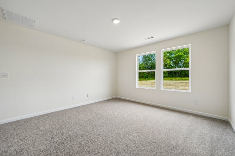 A room with a window and a carpet.